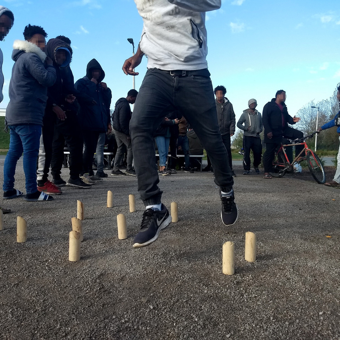 Young people in a group playing a game outside in France